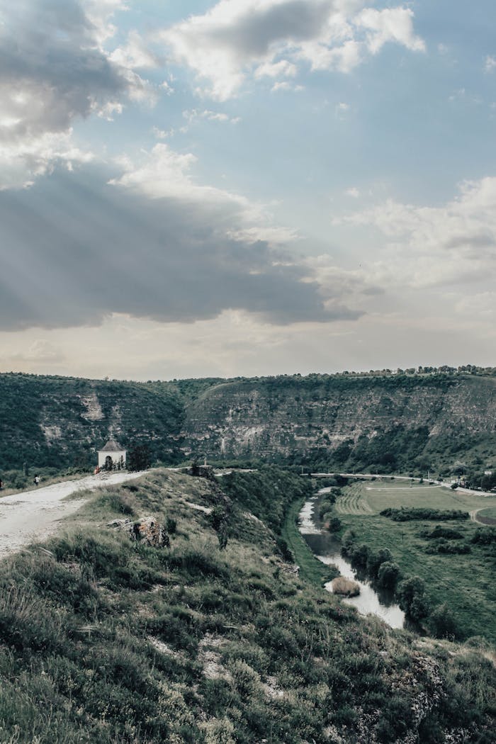 A stunning landscape of Old Orhei, Moldova featuring limestone formations and a winding river.